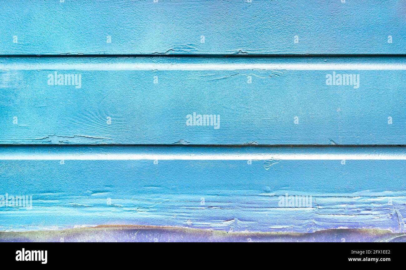 Blue painted background and alternative construction material - Wooden textured panel in outer fence structure - Retro old fashioned backdrop pattern Stock Photo