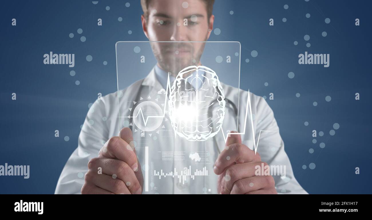 Composition of male doctor holding interactive screen with medical data ...