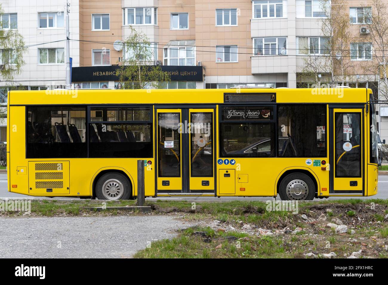 Yellow city bus. In city of day. Side view. Surgut, Russia - 17, May 2021. Stock Photo