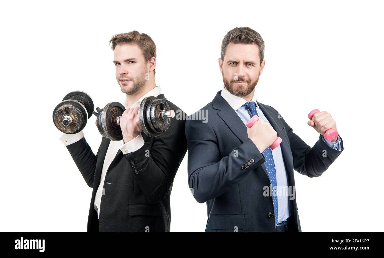 Strong and weak businessmen do dumbbell workout with hand weights, business competition Stock Photo
