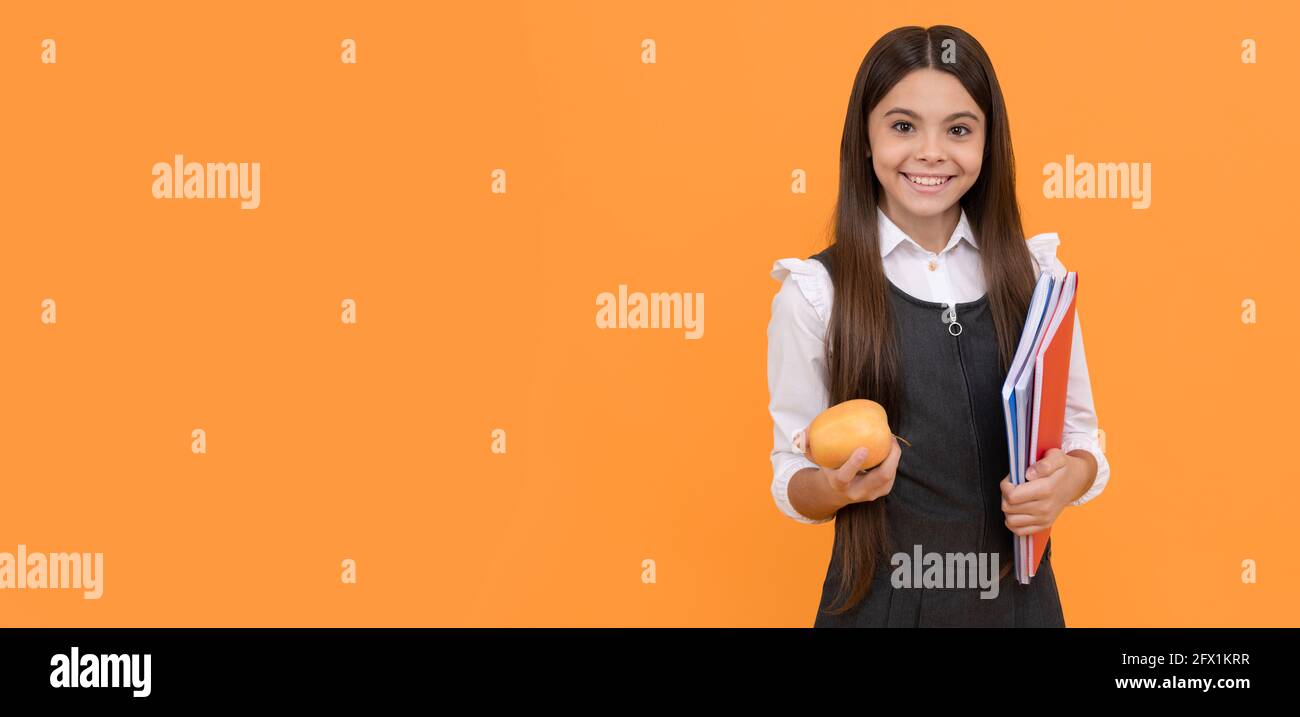 Individual study. Happy schoolgirl hold apple and books. Self study. Homework. School education Stock Photo