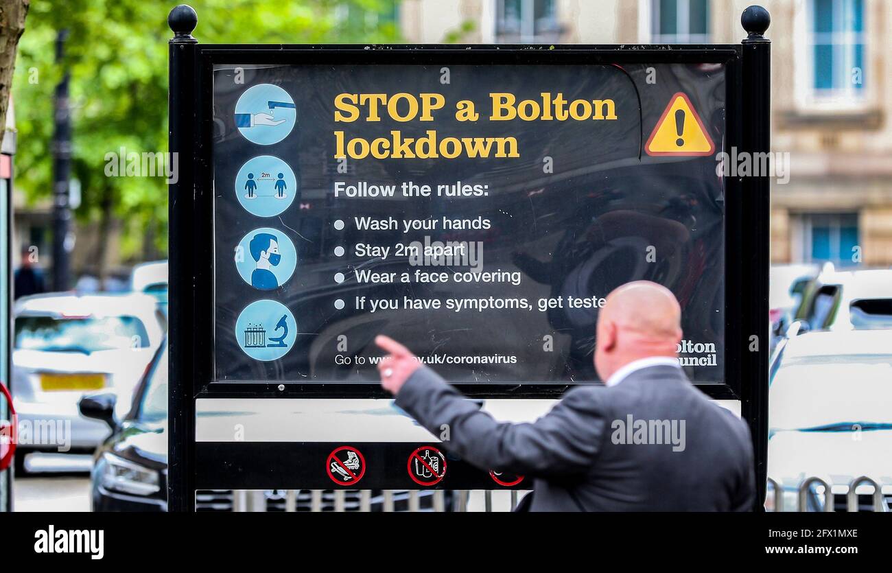 Coronavirus signage in Bolton town centre, one of the areas of the UK where the Covid variant first identified in India is spreading fastest. Picture date: Tuesday May 25, 2021. Stock Photo