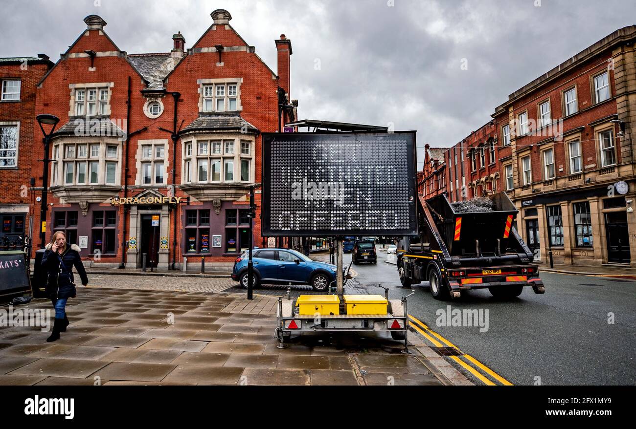 An electronic notice board in Bolton town centre, one of the areas of the UK where the Covid variant first identified in India is spreading fastest. Picture date: Tuesday May 25, 2021. Stock Photo
