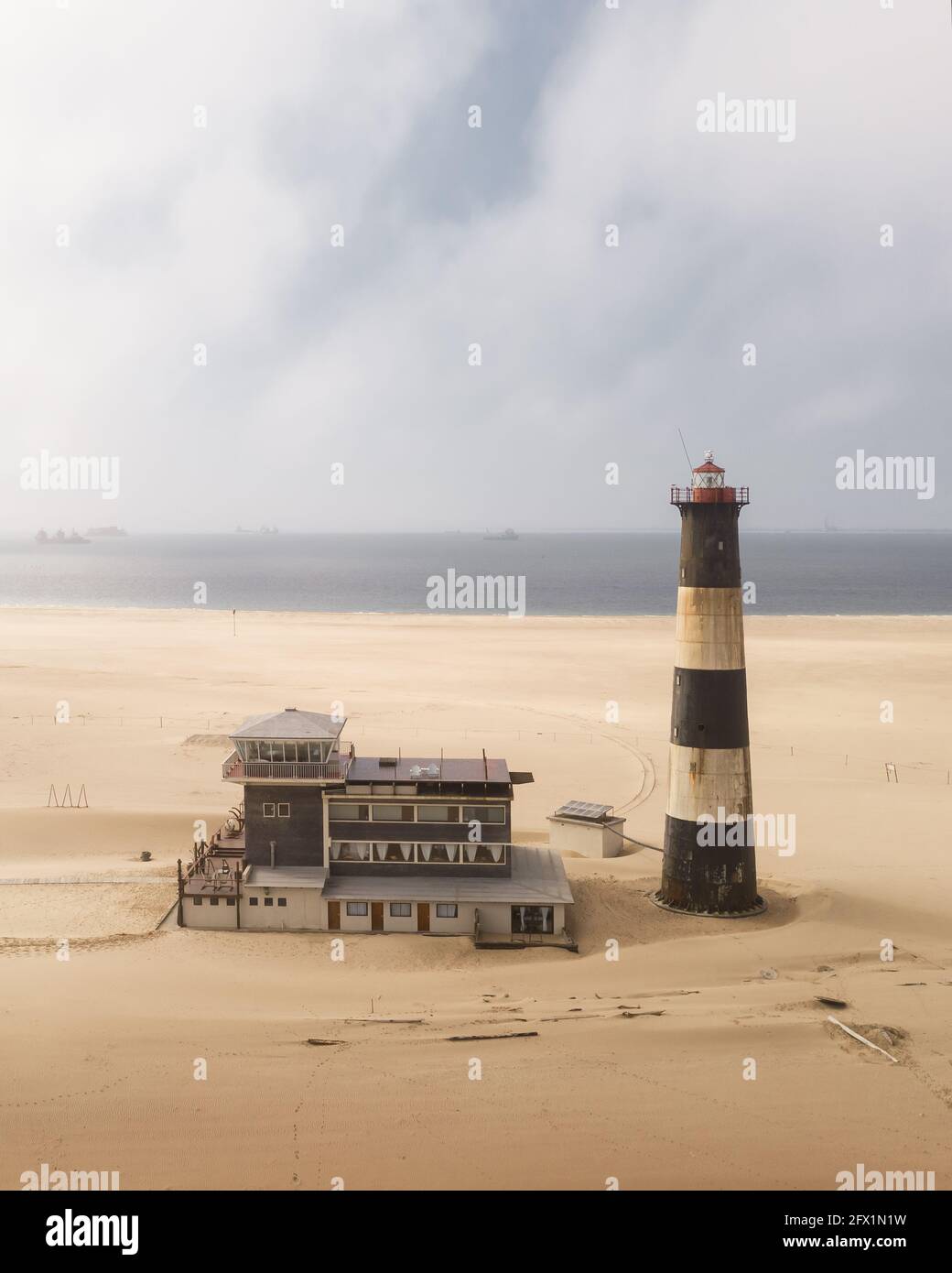 The oceanfront lighthouse at Sandwich Harbour in Namibia, Africa. Landscape drone photography Stock Photo