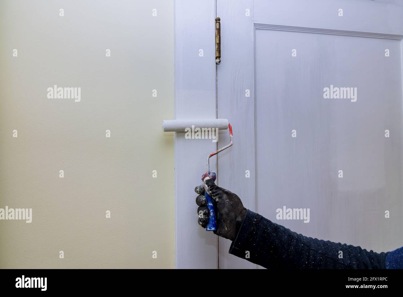 Contractor painter updating colors of painting doors molding trim using