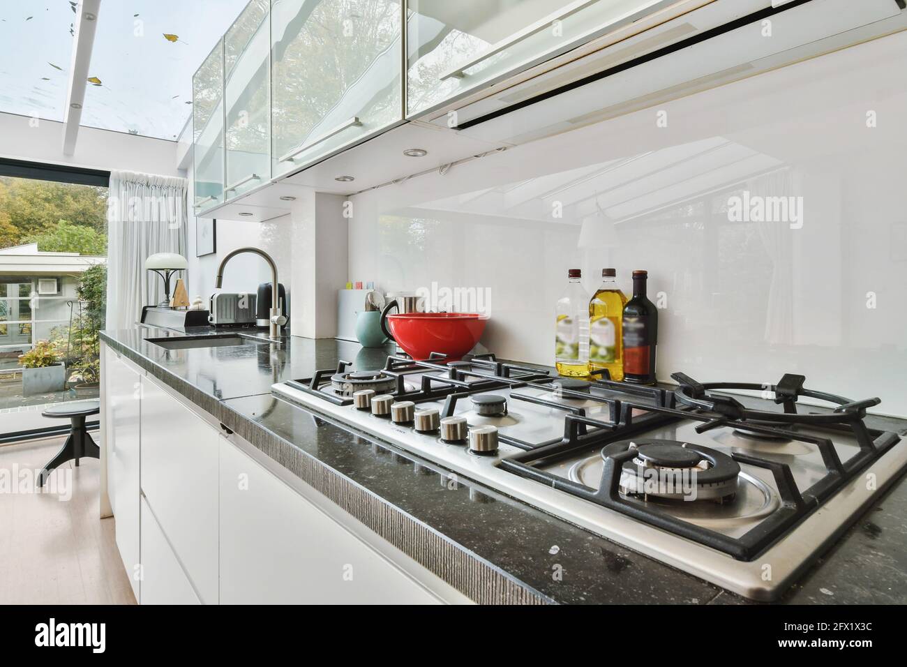 Spacious kitchen room with white and matte and built in chrome
