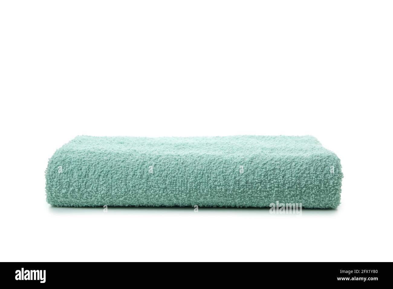 Green folded towel isolated on white background Stock Photo