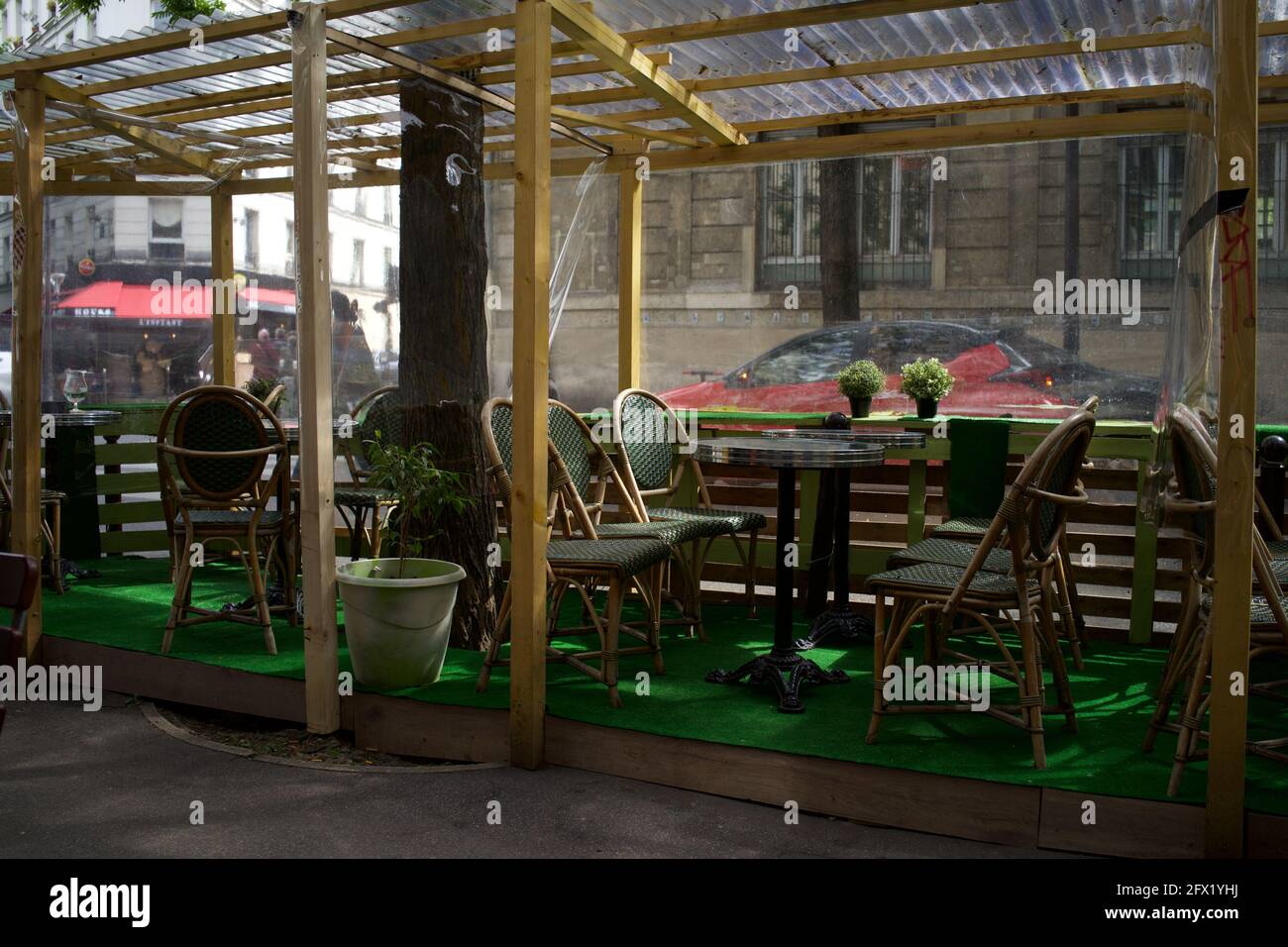 An empty cafe terrace awaits customers, one of many temporary terraces constructed on Paris' pavements to enable customers to drink outside after Covid-19 restrictions were eased in May 2021 - Le Montmartre Café, Rue Custine, 75018, Paris, France Stock Photo