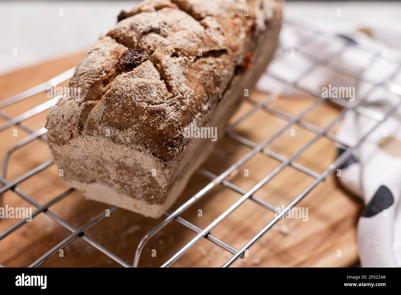 Sourdough homemade fruit bread on baking grid. Stock Photo