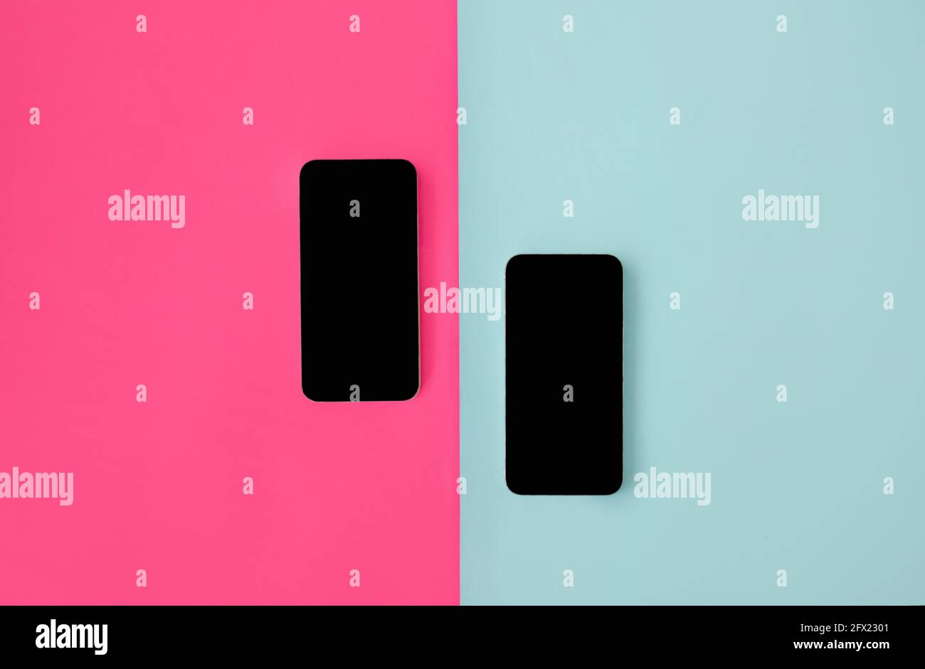 Two smartphones with blank screens on blue and pink backgrounds, top ...