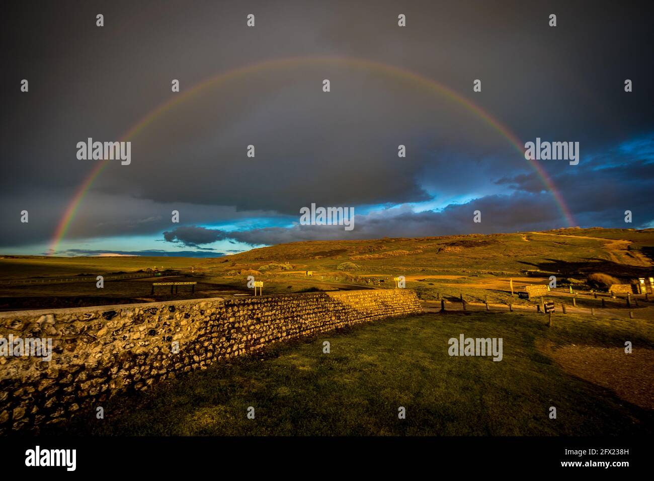 Sunset rainbow across the South downs of Sussex Stock Photo