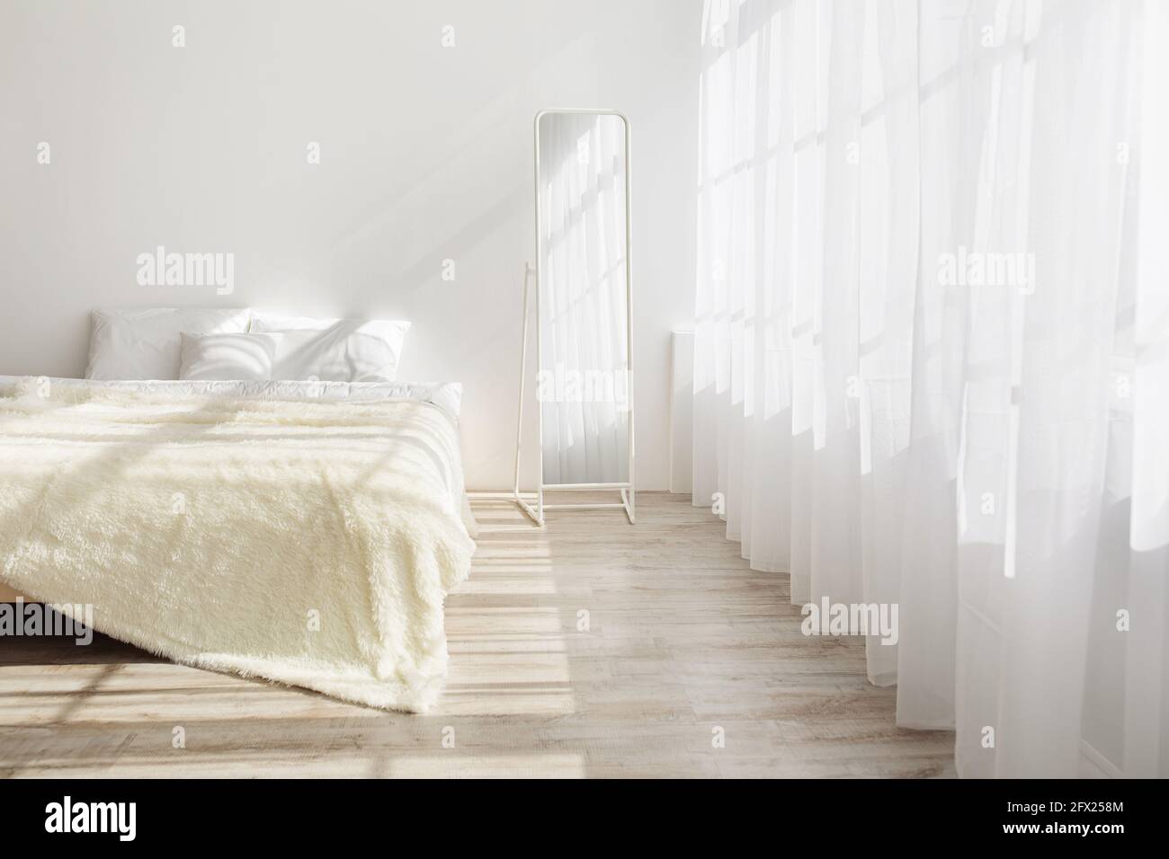 Morning in stylish bedroom in simple minimalist interior Stock Photo
