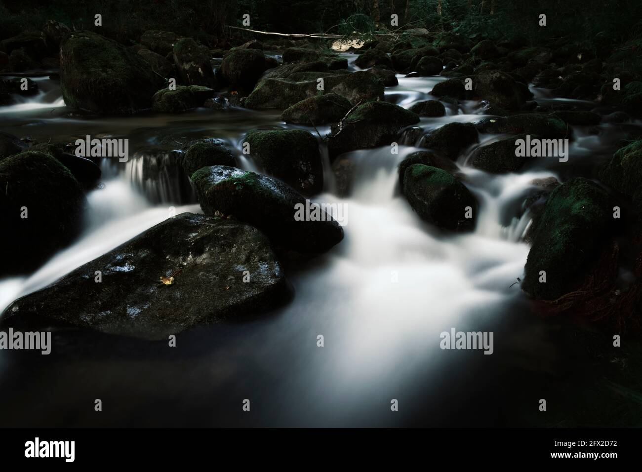 Long pause of a dark mountain river in France Stock Photo
