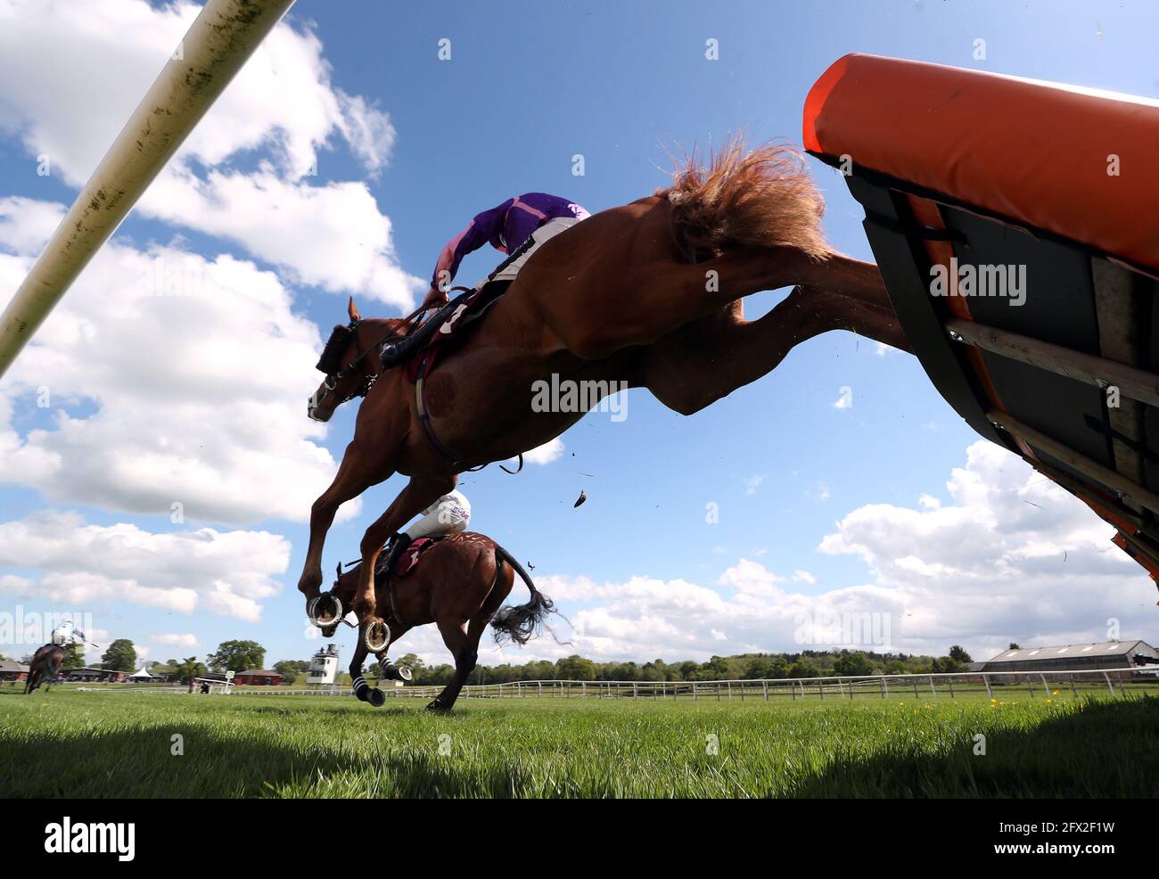 Danger Money ridden by jockey Brian Hughes clear a fence during the Penley Novices' Handicap Hurdle at Bangor-on-Dee Racecourse. Picture date: Tuesday May 25, 2021. Stock Photo