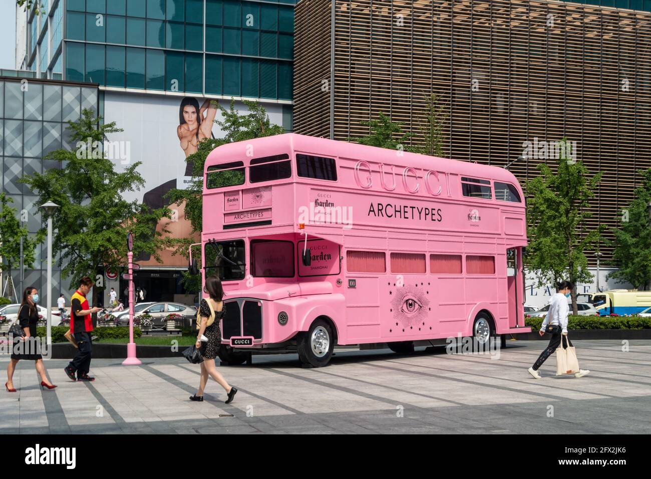 SHANGHAI, CHINA - MAY 25, 2021 - A double-decker bus with a vintage look  and pink color is parked on the street of Jing 'an Temple in Shanghai,  China, May 25, 2021.