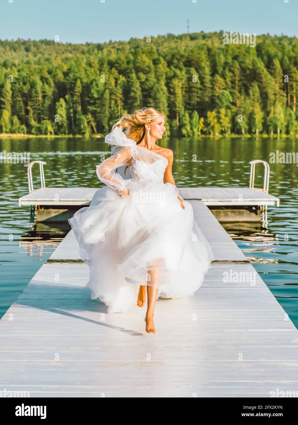 Bride runs barefoot towards happiness. Wedding concept Stock Photo