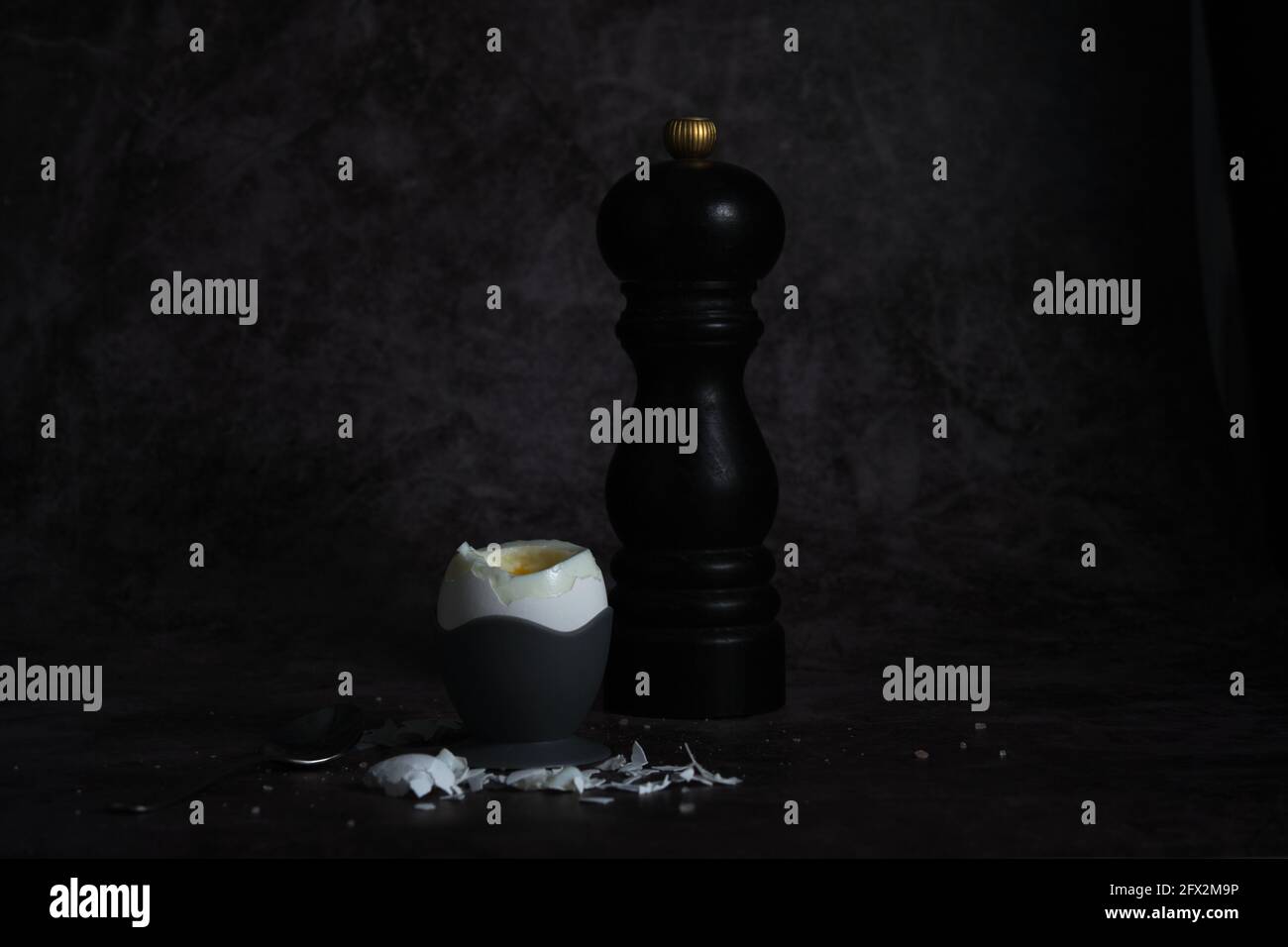 soft-boiled egg on a stand on a dark background Stock Photo