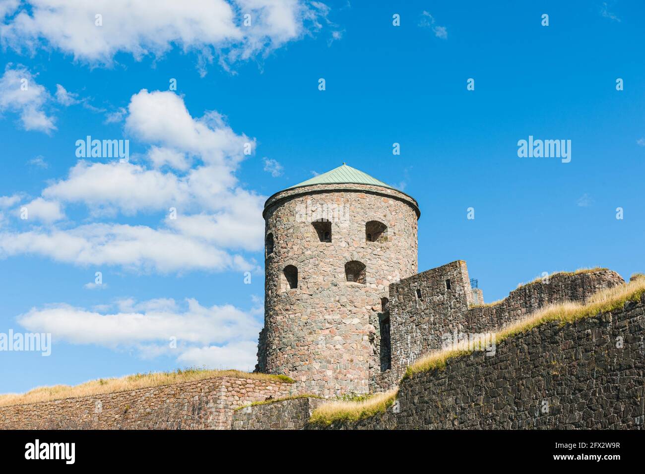 Old fortress tower against blue sky Stock Photo