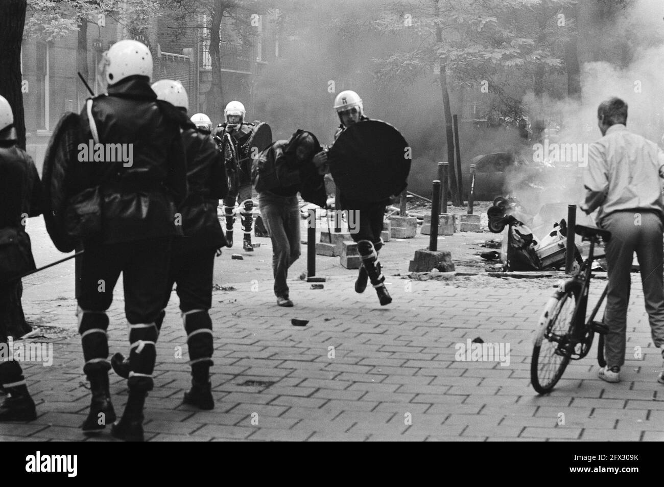 ME with detainee, October 11, 1982, detainees, squats, police officers ...