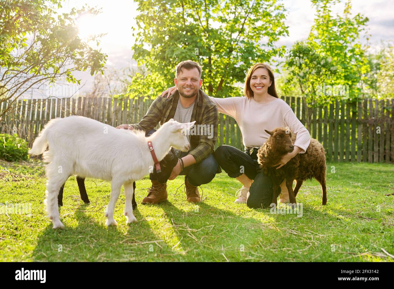 Small farm with ouessant sheep and goat, portrait of family couple of