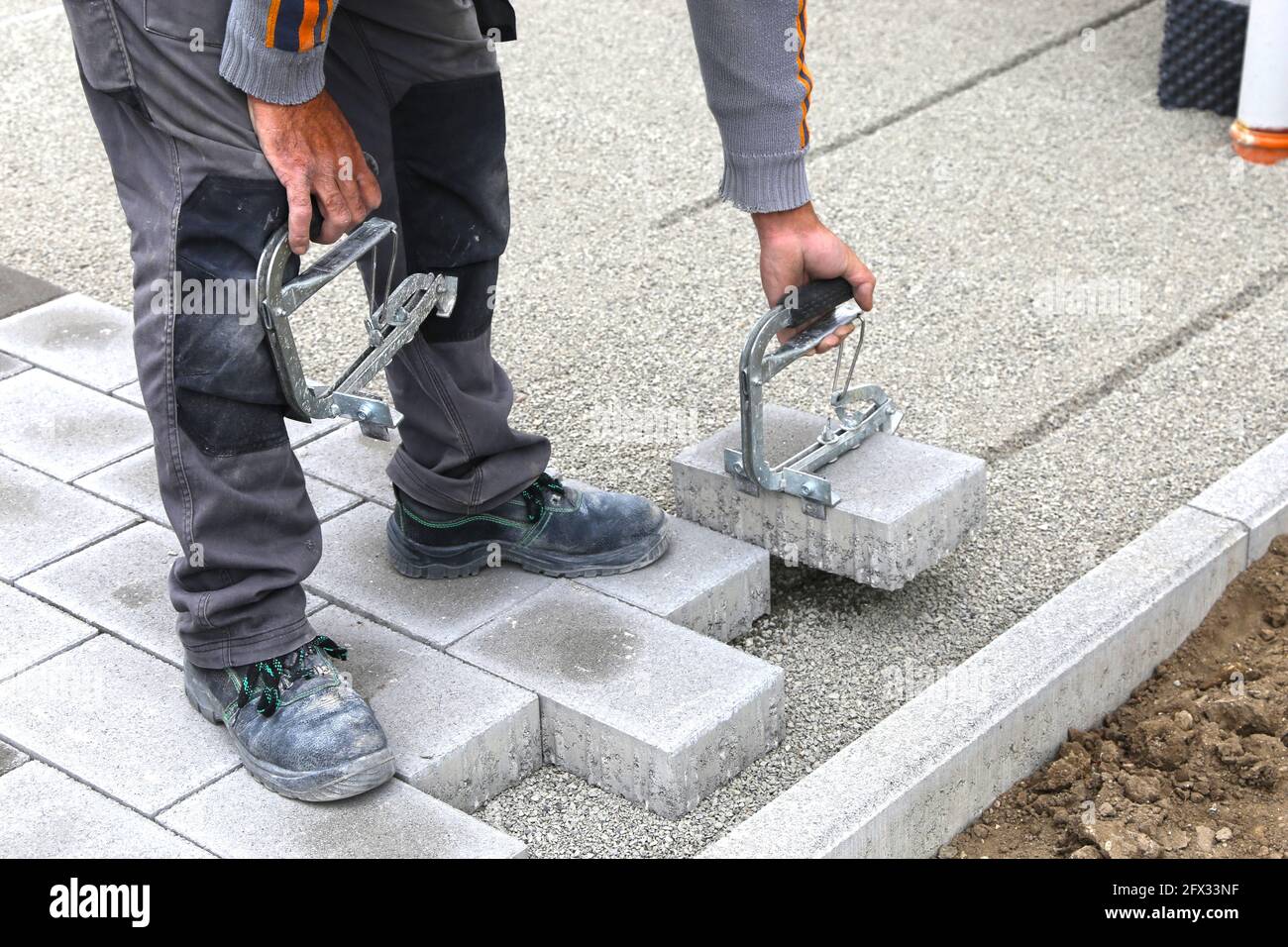 Construction worker lay paving stones Stock Photo