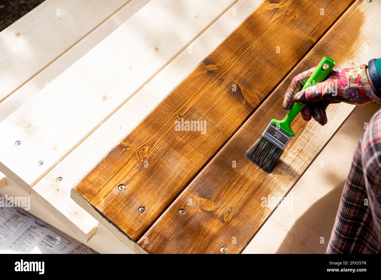 Painting wooden patio deck with protective varnish Stock Photo Alamy