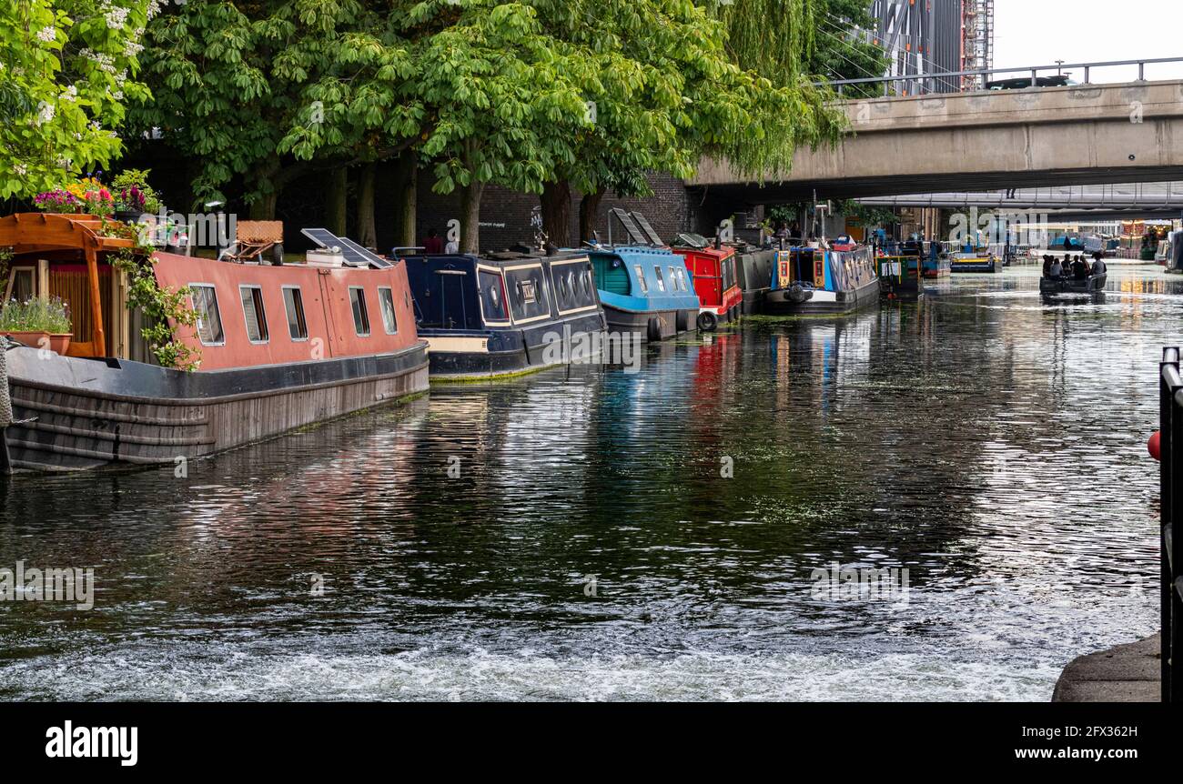 Paddington Basin – Detail of Several Moored Barges Along the Bank of Little Venice with Reflections and Road Bridge at Paddington. Stock Photo