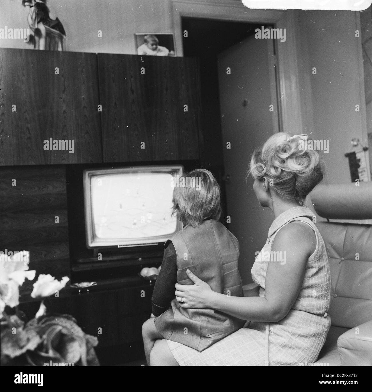 Mrs. Muller watches soccer game on TV with her little daughter, September  18, 1968, television, The Netherlands, 20th century press agency photo,  news to remember, documentary, historic photography 1945-1990, visual  stories, human