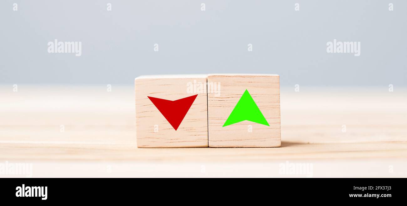 wood cube block with UP and Down arrow symbol icon on table. Interest rate, stocks, financial, ranking, mortgage rates and Cut loss concept Stock Photo