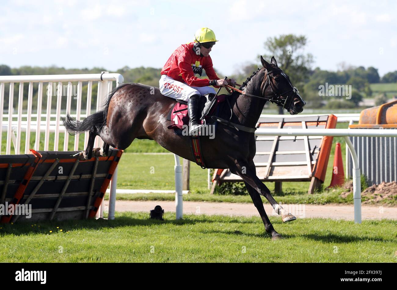 Butler's Brief and jockey Nick Scholfield clear a fence on their way to winning the Bangor-On-Dee Leading Jockey 2020-2021 Season Handicap Hurdle at Bangor-on-Dee Racecourse. Picture date: Tuesday May 25, 2021. Stock Photo