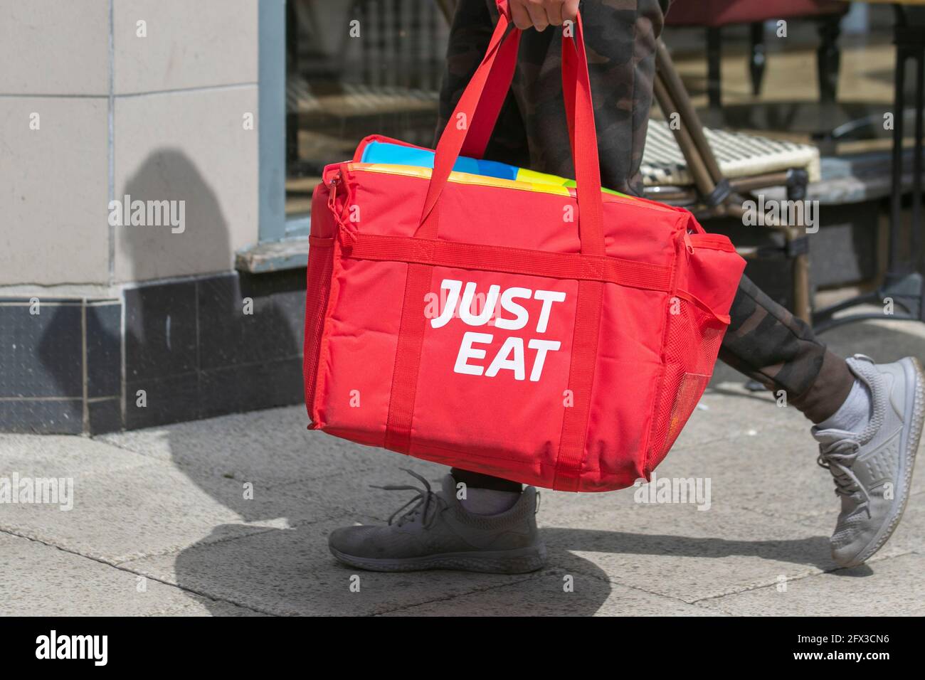 Just Eat insulated orange red carrier;  takeaway online lunches on order in Preston city centre, UK Stock Photo