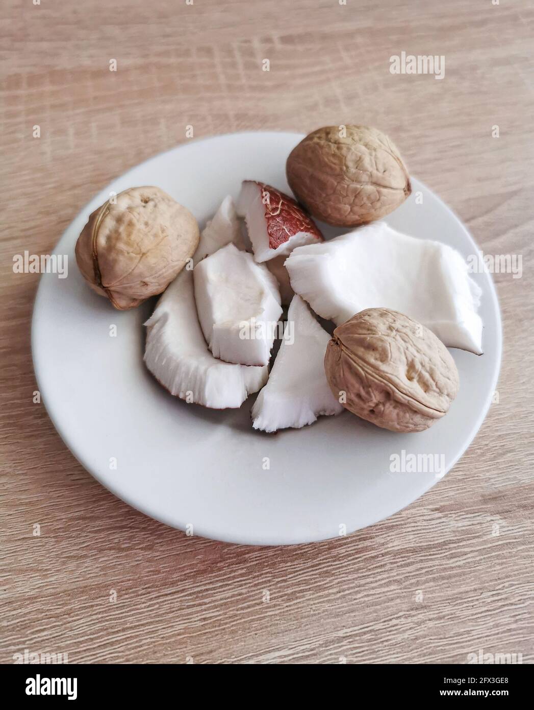 Nuts. Fresh coconut pieces and walnuts. Omega 3 and omega 6 fatty acids, healthy protein, vitamins and minerals Stock Photo