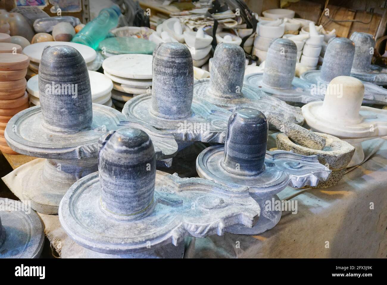 Haridwar, Garhwal, India - 3rd November 2018 : Auspicious Shiv Lingas made of stone, displayed for sale. Night image of Motibazar, a famous market pla Stock Photo