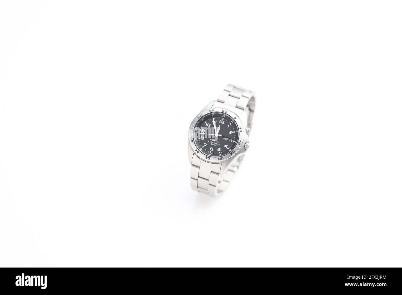 Chrome Wristwatch on white background showing five minutes to twelve Stock Photo