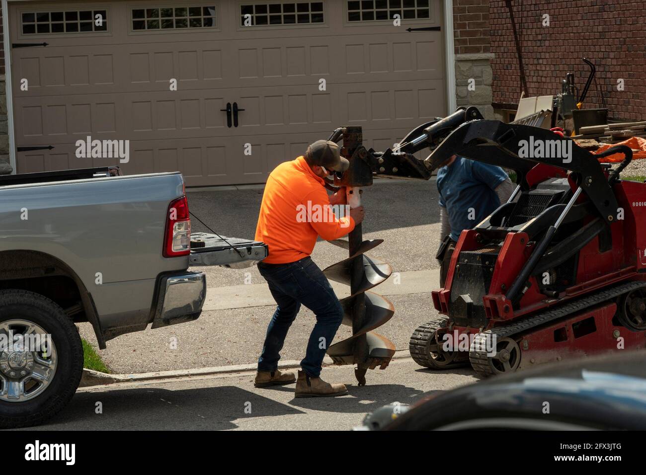 Installation and fastening of a large drill for drilling holes in the ground for planting trees