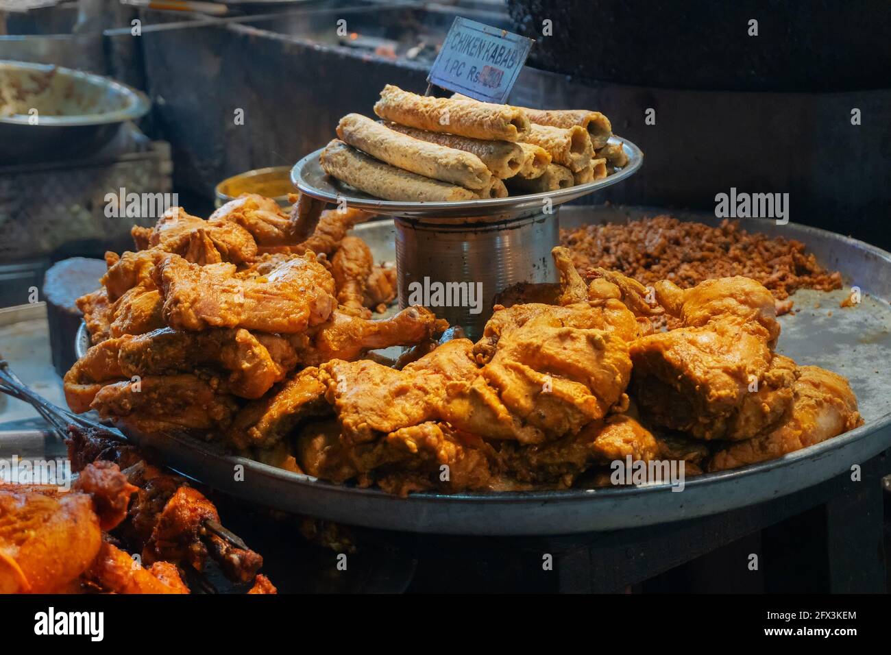 Spicy roasted tandoori butter chicken , prepared for sale at evening as street food in Old Delhi