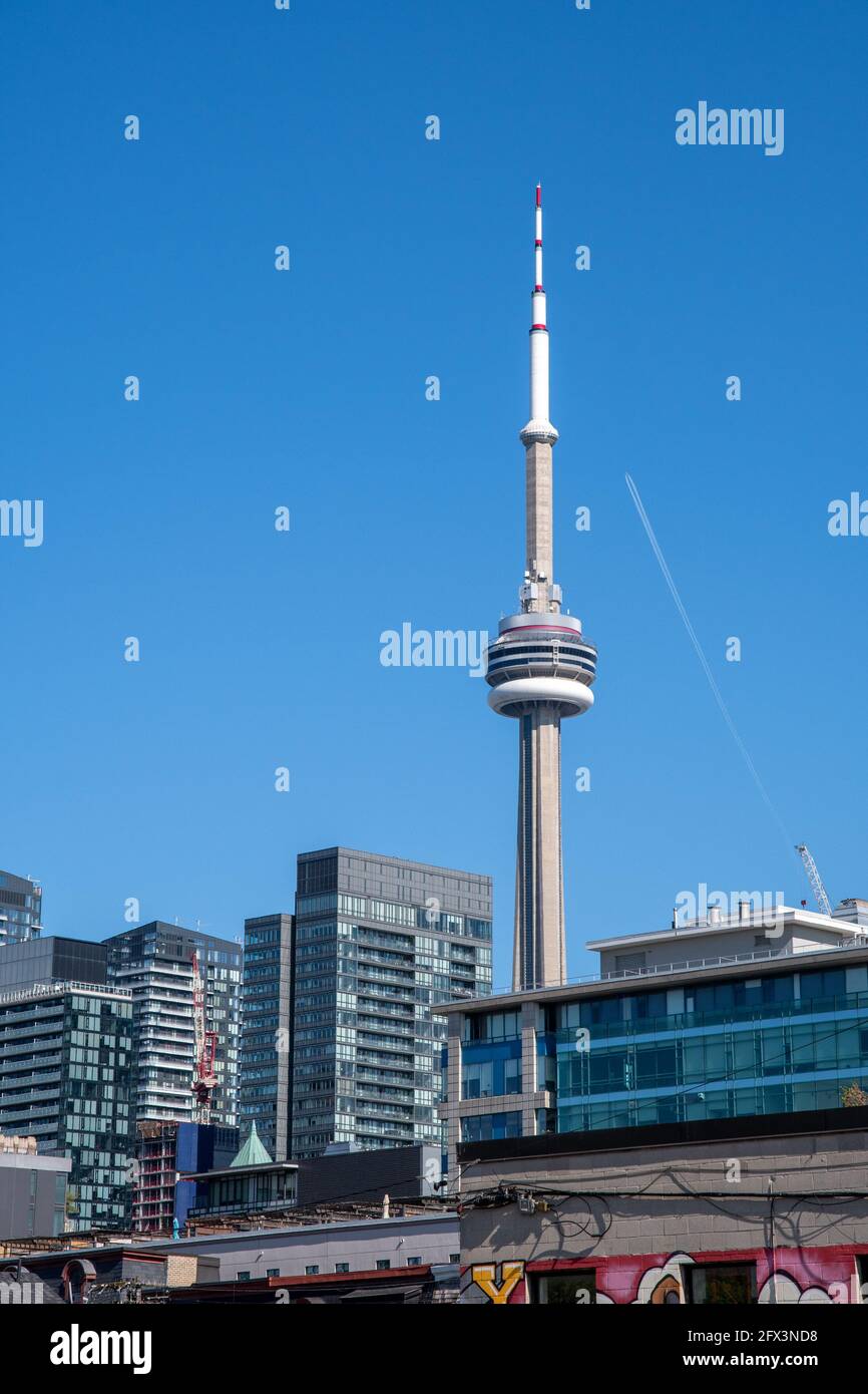 The CN Tower in a beautiful blue sky day in Toronto, Canada. A point of view from Queen Street West. Stock Photo