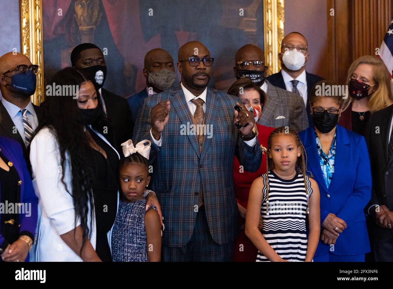 Philonise floyd, brother of George Floyd, speaks to the press while  standing with House Speaker Nancy Pelosi, Dp-CA, other members of the Floyd family  prior to a meeting to mark the anniversary