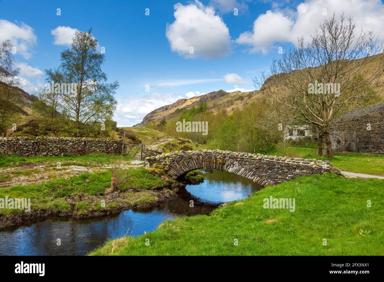 The Packhorse bridge over Watendlath Beck at Watendlath Tarn, Lake District, England Stock Photo