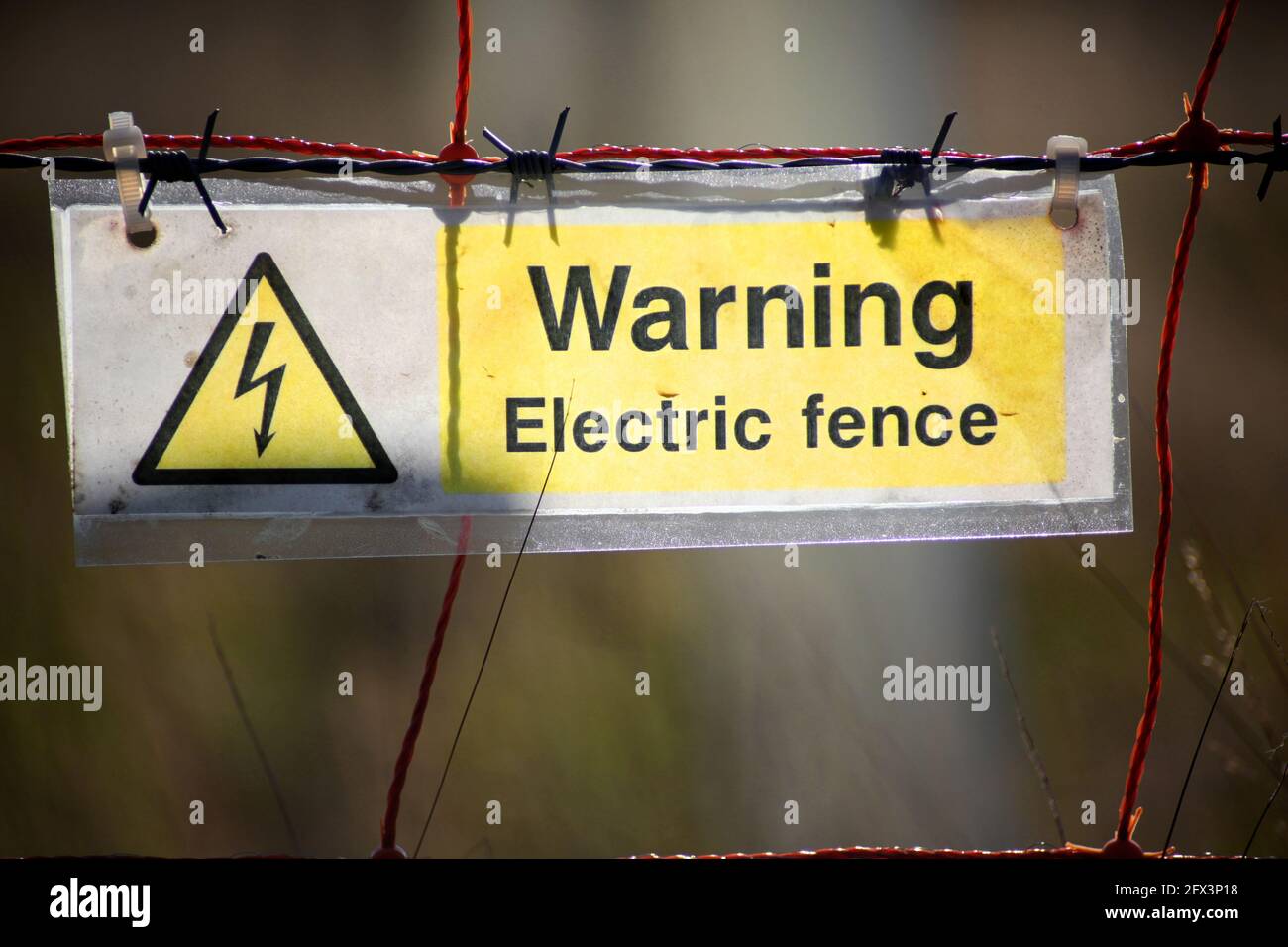 An electric fence warning sign Stock Photo