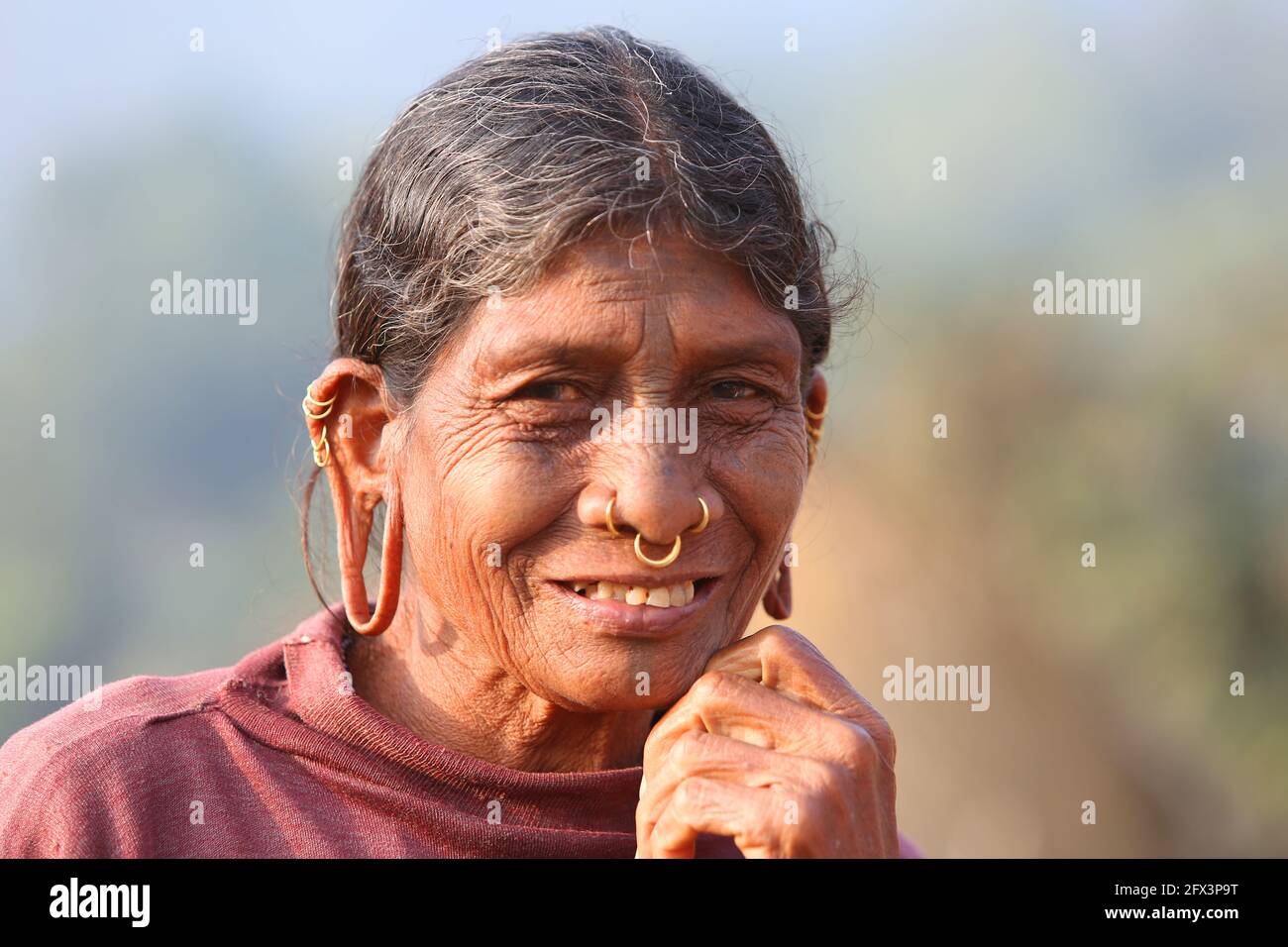 LANJIA SAORA TRIBE - Tribal woman close-up. These tribal people consider that the longer the ear holes in the female members the more beautiful they a Stock Photo