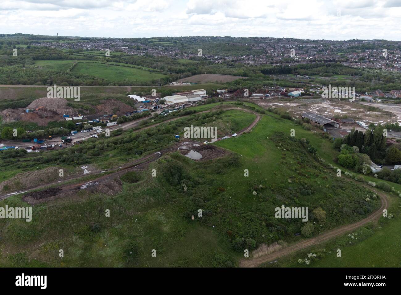 Kingswinford, UK. 25th May, 2021. Aerial views of Himley Quarry Landfill where a poice scene has been set up after a human bone was found. A blue tent is visible along with police vehicles and officers. West Midlands Police are searching the site, on top of a landfill mound after the grim discovery. Pic by Credit: Katie Stewart/Alamy Live News Stock Photo