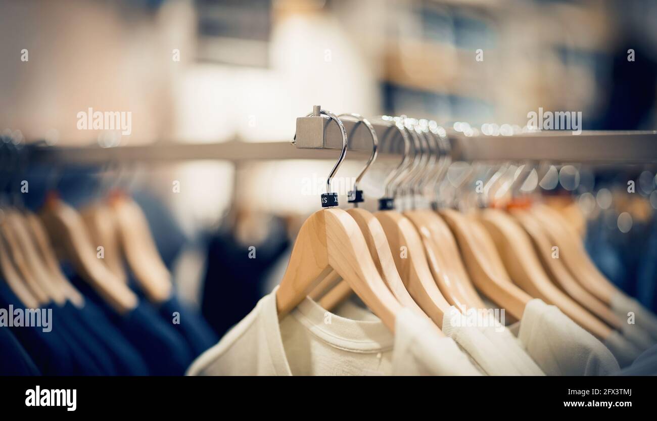 T-shirts on hangers. Shopping in store. Clothes on hangers in shop for  sale. Blur background. Fashionable clothes in a boutique. Various clothing  on m Stock Photo - Alamy