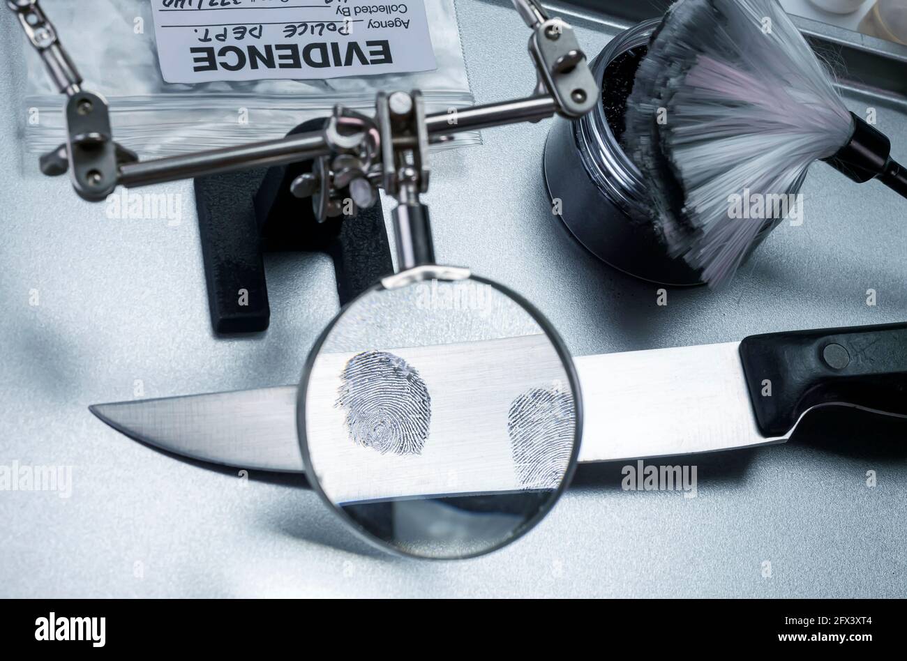 Police investigation of fingerprint on a knife, concept image Stock Photo