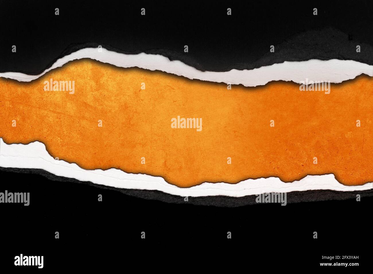 Hole ripped in paper on orange background Stock Photo