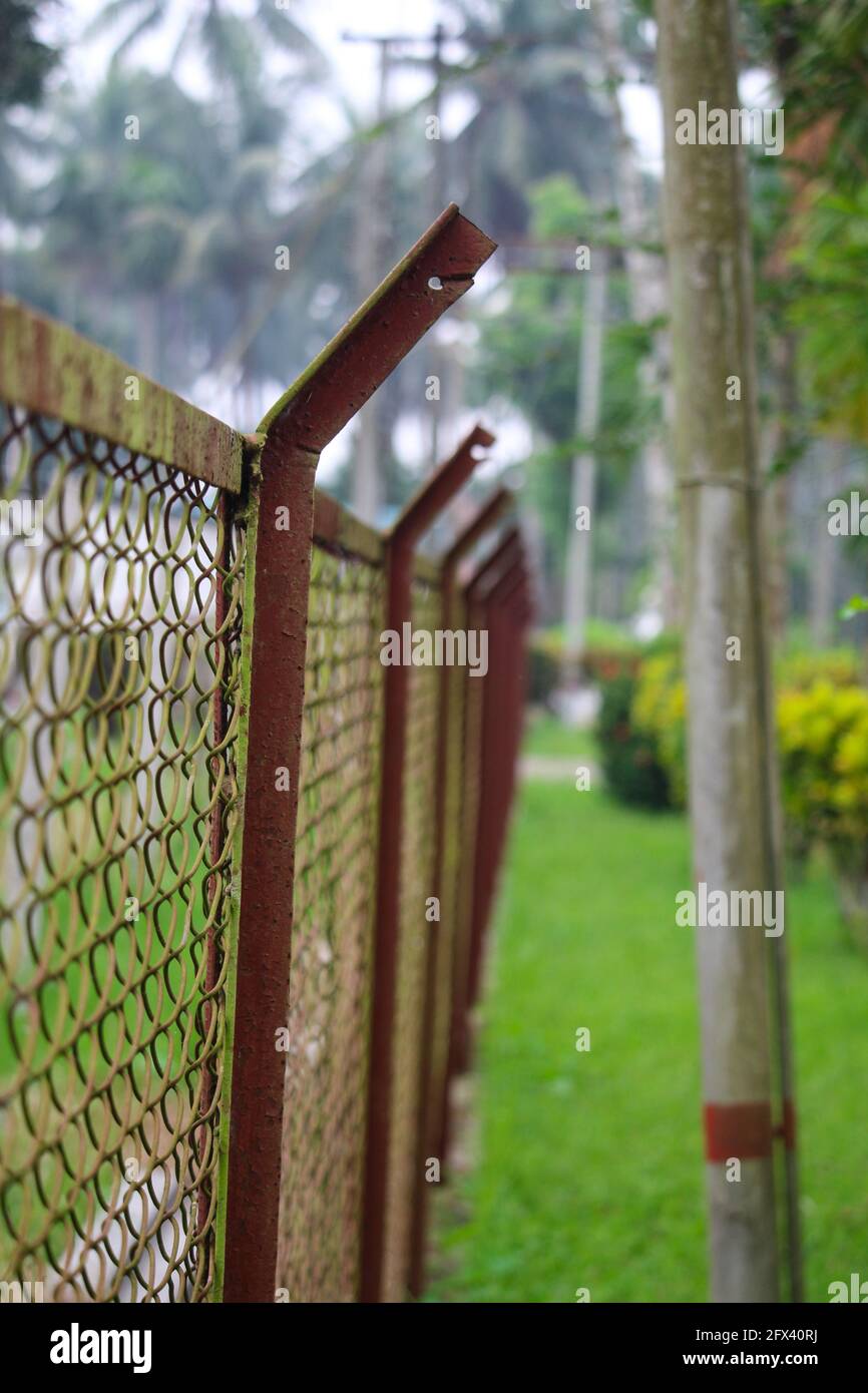Chain link fencing around a local club tennis court Stock Photo