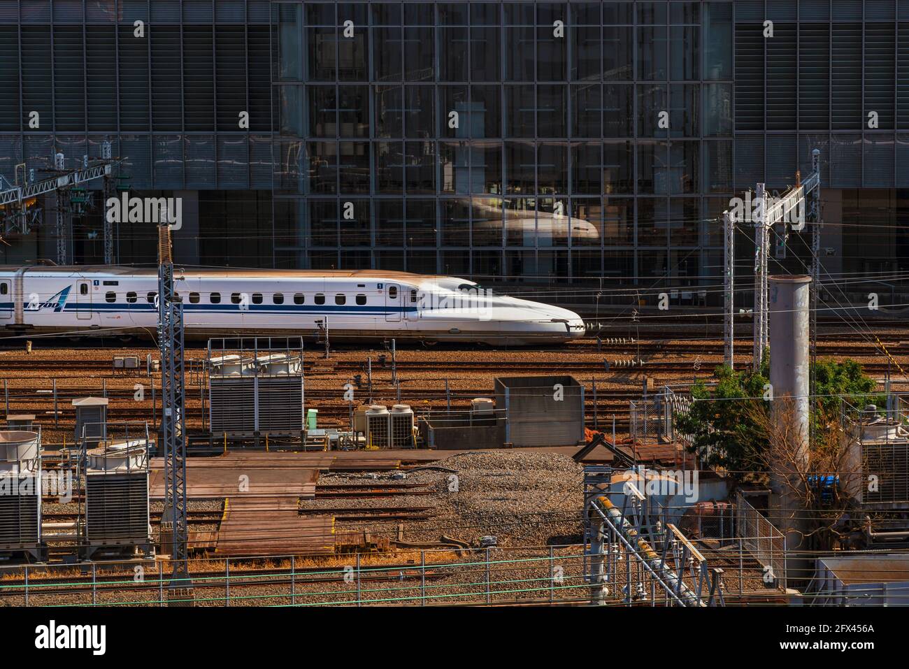 A Shinkansen, the famous japanese bullet train, passes through Tokyo urban area Stock Photo