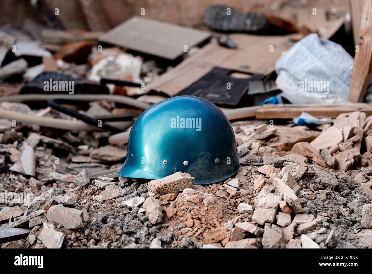 A helmet on a pile of debris. Warzone concept image. Stock Photo