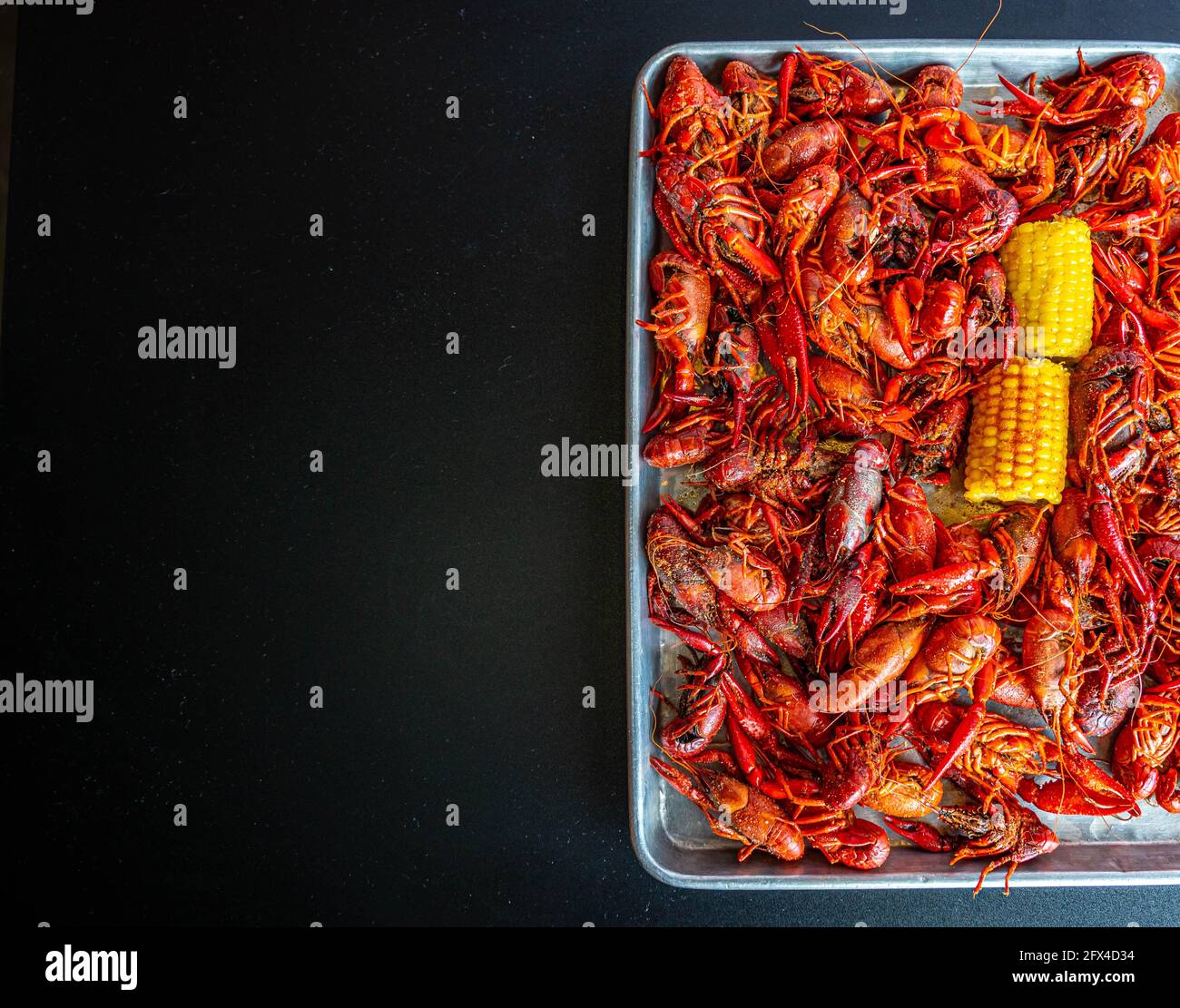 Boiled Crawfish and Yellow Corn on the cob Stock Photo