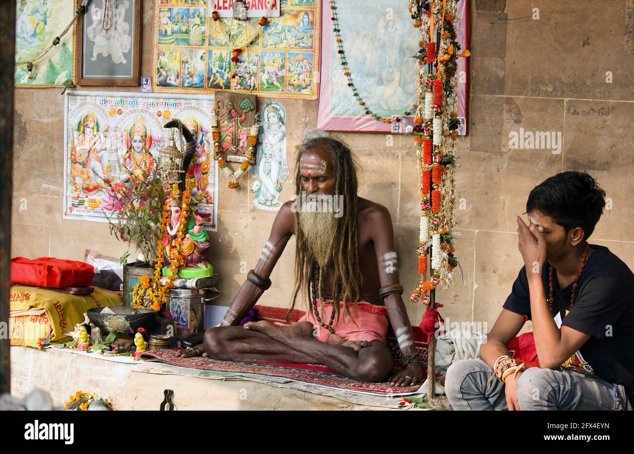 Varanasi, India - November 01, 2016: Portrait of a hindu white bearded sadhu, pilgrim or Aghori baba with closed eyes meditating. dreadlocked hindu ma Stock Photo